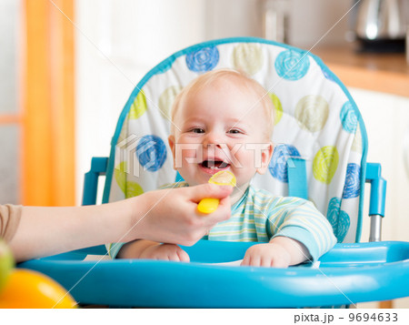 mother spoon feeding baby boy mother spoon feeding baby boy 9694633