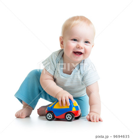 smiling kid playing with toy smiling kid playing with toy 9694635