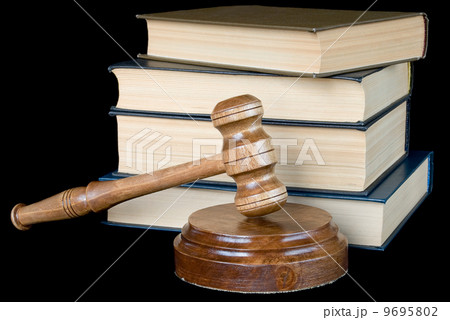 Wood gavel and books on a black background 9695802