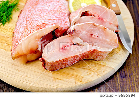 Fillet of sea bass with dill on board Fillet of sea bass with dill on board 9695894