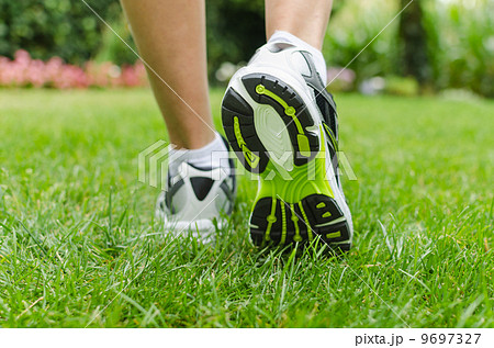 Woman running on grass Woman running on grass 9697327
