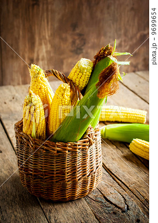 Fresh Corn in a Basket on the wooden table 9699654
