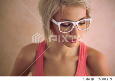 Beautiful young blond girl with short hair wearing glasses in pi 9700319