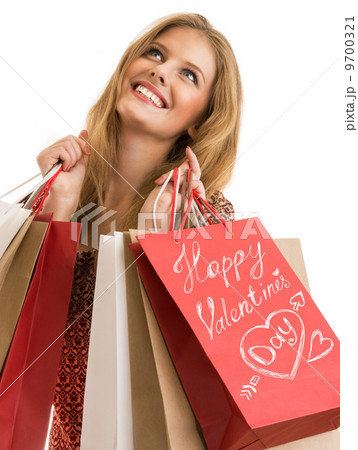 Shopping woman holding shopping bags looking upwards 9700321
