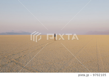 The figure of a man in the empty desert landscape of Black Rock desert, Nevada. 9702105