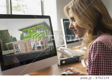 Architects discussing a green construction project, designing and building efficient environmentally friendly buildings. Green architectural practice. 9702159