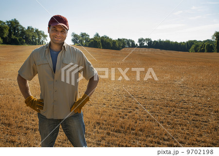 A man standing by a freshly ploughed field. A man standing by a freshly ploughed field. 9702198