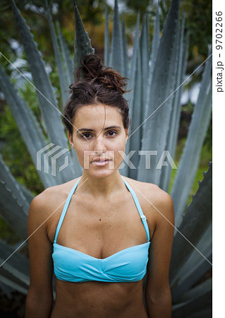 Young woman in front of an agave plant in Las Galeras, Samana Peninsula, Dominican Republic. Young woman in front of an agave plant in Las Galeras, Samana Peninsula, Dominican Republic. 9702266