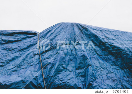 A blue tarpaulin covering stacked commercial fishing nets on the dockside at Fisherman's Wharf, Seattle. A blue tarpaulin covering stacked commercial fishing nets on the dockside at Fisherman's Wharf, Seattle. 9702402