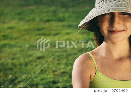 Portrait of smiling nine year old girl sitting on the grass Portrait of smiling nine year old girl sitting on the grass 9702409