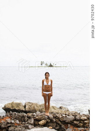 A young woman on the shore on a cloudy day in Las Galeras, Samana Peninsula, Dominican Republic. 9702430