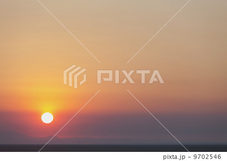 The rising sun over flat desert landscape at dawn in Nevada. The rising sun over flat desert landscape at dawn in Nevada. 9702546