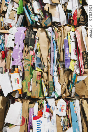 Recycling facility with bundles of cardboard sorted and tied up for recycling. 9702635