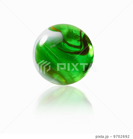 A green glass marble with an interior pattern. 9702692