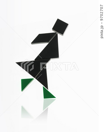 A number of triangles, squares and shapes arranged to represent a human being, in motion or action. 9702707