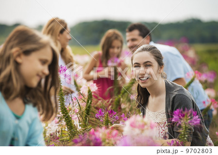 A group of people among the flowers at an organic Flower Farm. 9702803