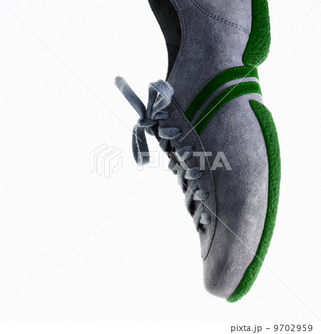 A single sneaker or trainer shoe with laces and green sole. 9702959
