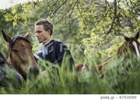 A man with a blue jumper at home on his property. 9703090