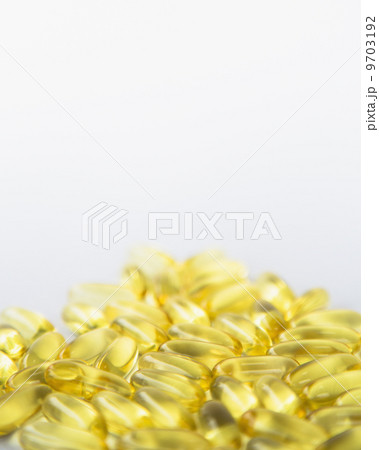 Fish oil providing Omega-3, in softgel supplement capsules. An essential fatty acid and health supplement product. 9703192