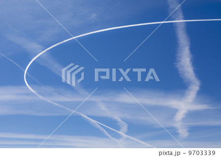 Jet trail across blue sky 9703339