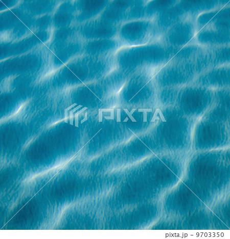 The moving water on the surface of a pool. Reflections and ripples catching the light. 9703350