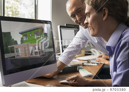 Architects discussing a green construction project, designing and building efficient environmentally friendly buildings. Green architectural practice. 9703380