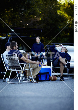 A group of friends at a barbeque or tailgate party at an event. A group of friends at a barbeque or tailgate party at an event. 9703446