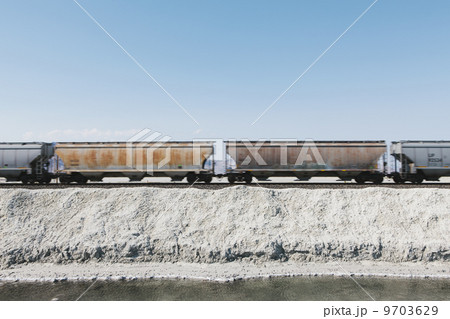 A goods train in the desert on railway tracks. Freight carrier. 9703629