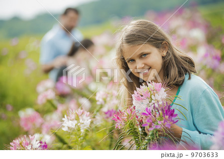 Three people among the flowers at an organic Flower Farm. 9703633