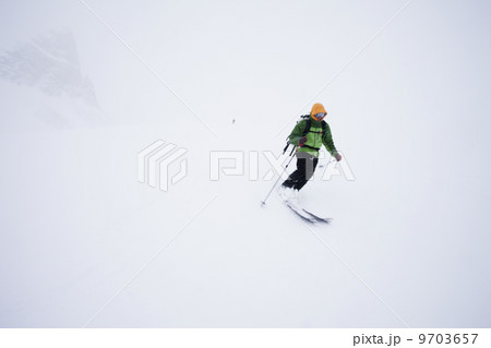 A skier in powder snow in mist and cloud conditions on the Wapta Traverse, a mountain hut to hut ski tour in Alberta, Canada. 9703657