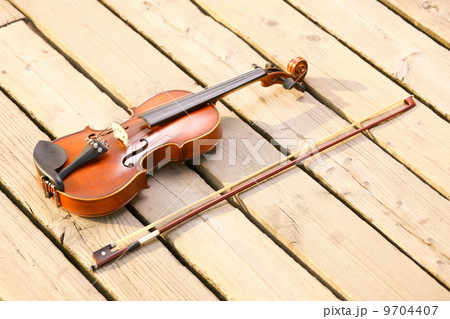 Violin on wooden pier. Music concept 9704407