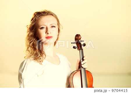 The blonde girl with a violin outdoor 9704415