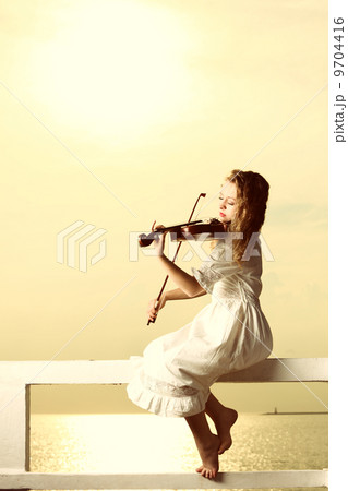 The blonde girl with a violin outdoor 9704416