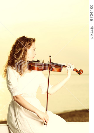 The blonde girl with a violin outdoor 9704430