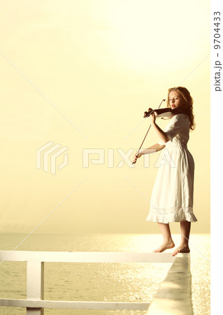 The blonde girl with a violin outdoor 9704433