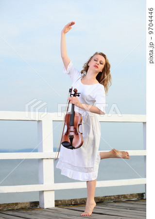 The blonde girl with a violin outdoor 9704446