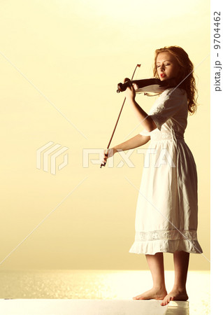 The blonde girl with a violin outdoor The blonde girl with a violin outdoor 9704462