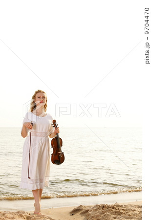 The blonde girl with a violin outdoor 9704470