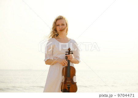 The blonde girl with a violin outdoor 9704471