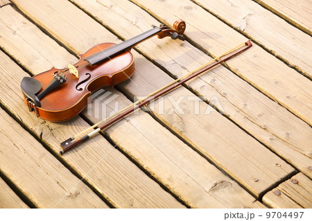 Violin on wooden pier. Music concept 9704497