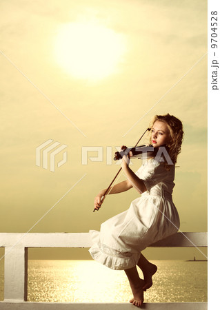 The blonde girl with a violin outdoor 9704528