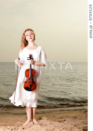The blonde girl with a violin outdoor 9704529