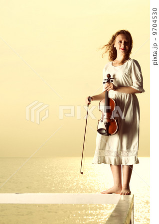 The blonde girl with a violin outdoor 9704530