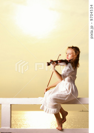 The blonde girl with a violin outdoor 9704534