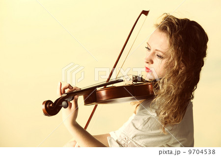 The blonde girl with a violin outdoor 9704538