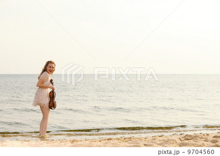 Happy blonde girl with a violin outdoor 9704560