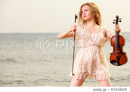The blonde girl with a violin outdoor The blonde girl with a violin outdoor 9704609