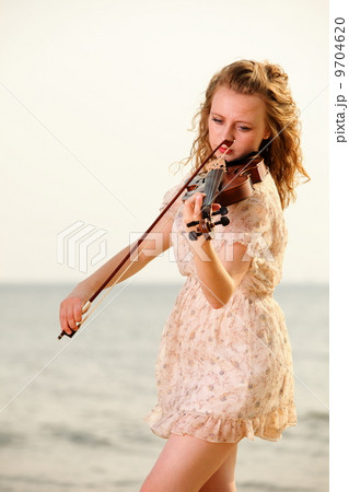 The blonde girl with a violin outdoor 9704620