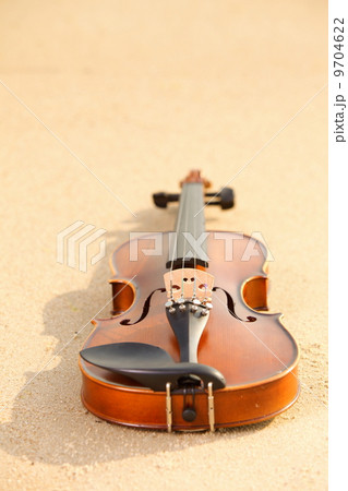 Violin on sandy beach. Music concept 9704622
