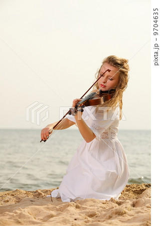 The blonde girl with a violin outdoor 9704635